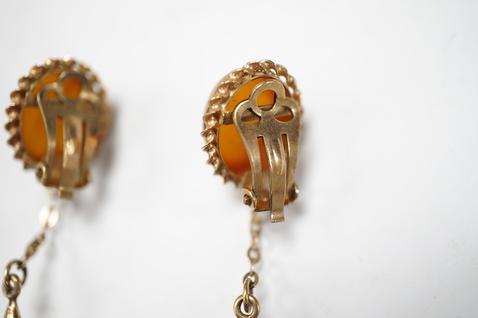 A pair of yellow metal and two stone amber set drop ear clips, 68mm, gross weight 8 grams. Condition - poor